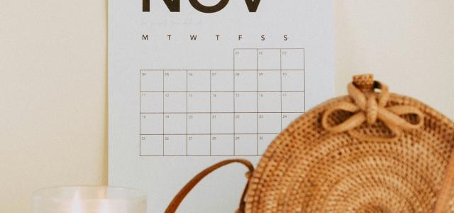 shallow focus photo of calendar mounted on white wall by Maddi Bazzocco courtesy of Unsplash.